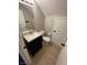 Bathroom featuring sleek vanity with a dark wood finish, and updated fixtures, complementing tile flooring at 3025 Sunrise Bay Ave, North Las Vegas, NV 89031