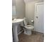 Bathroom featuring a pedestal sink, toilet, and tile flooring that enhance the clean and simple design at 3025 Sunrise Bay Ave, North Las Vegas, NV 89031