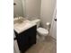 Cozy bathroom features a modern vanity with a speckled countertop, complementing fixtures and tile flooring at 3025 Sunrise Bay Ave, North Las Vegas, NV 89031