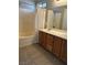 Bathroom boasts double vanity and tub-shower with white tile at 3025 Sunrise Bay Ave, North Las Vegas, NV 89031