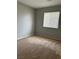 Clean bedroom with neutral carpet, light gray walls, and a window at 3025 Sunrise Bay Ave, North Las Vegas, NV 89031