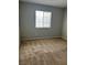 Simple bedroom with neutral walls, carpeted flooring, and a window at 3025 Sunrise Bay Ave, North Las Vegas, NV 89031