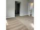 Spacious bedroom with neutral carpet and open doorway to a closet or bathroom at 3025 Sunrise Bay Ave, North Las Vegas, NV 89031