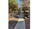 Stone-covered community walkway with lush trees and shrubs creating a park-like setting at 3025 Sunrise Bay Ave, North Las Vegas, NV 89031