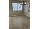 Dining area showcasing ceramic tile floor, a hanging light fixture, and natural light from the window at 3025 Sunrise Bay Ave, North Las Vegas, NV 89031