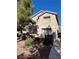 Tan two-story house with a red tile roof, landscaping, and a gated entrance at 3025 Sunrise Bay Ave, North Las Vegas, NV 89031