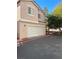 Two story townhome with a stucco exterior and attached two car garage at 3025 Sunrise Bay Ave, North Las Vegas, NV 89031