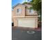 Two story townhome with a stucco exterior and attached two car garage at 3025 Sunrise Bay Ave, North Las Vegas, NV 89031