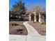 Charming walkway leading to the house, landscaped with rocks and desert plants at 3025 Sunrise Bay Ave, North Las Vegas, NV 89031