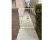 Side yard access via ornate white metal gate, set between homes and leading to an enclosed walkway at 3025 Sunrise Bay Ave, North Las Vegas, NV 89031