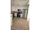 Well-equipped kitchen with stainless steel appliances, ample white cabinetry, and durable tile flooring at 3025 Sunrise Bay Ave, North Las Vegas, NV 89031