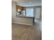 Kitchen featuring wooden cabinetry, a breakfast bar, and tile floors for a cozy and functional space at 3025 Sunrise Bay Ave, North Las Vegas, NV 89031