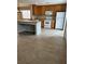 Open kitchen features tile flooring, wood cabinets, an island, and white appliances at 3025 Sunrise Bay Ave, North Las Vegas, NV 89031