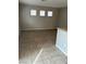 Living room area featuring neutral walls, ceramic tile flooring, and natural light from three windows at 3025 Sunrise Bay Ave, North Las Vegas, NV 89031