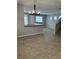 Open concept living room with tile flooring and a modern light fixture, offering seamless flow at 3025 Sunrise Bay Ave, North Las Vegas, NV 89031