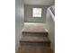 Carpeted stairs lead to the upper level, offering comfort and quiet with a view of the landing and window at 3025 Sunrise Bay Ave, North Las Vegas, NV 89031