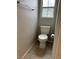 Small half-bath includes a toilet with tile flooring at 3025 Sunrise Bay Ave, North Las Vegas, NV 89031