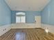 Light blue living room with wood-look floors and vaulted ceiling at 3760 Yorba Linda Dr, Las Vegas, NV 89122