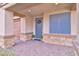 Front porch with gray door and stone accents at 4025 Redwood Glen Ct, Las Vegas, NV 89141