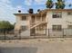 Two-story building with a metal fence and satellite dishes at 412 S Maryland Pkwy, Las Vegas, NV 89101