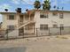 Two-story building with a metal fence and satellite dishes at 412 S Maryland Pkwy, Las Vegas, NV 89101