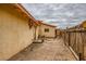 Backyard with rustic fence and exterior building and a small concrete patio at 4214 Bay Cir, Las Vegas, NV 89122