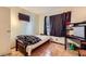 A small bedroom with a mini-fridge, TV and tile floors at 4214 Bay Cir, Las Vegas, NV 89122