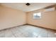 Bedroom with neutral walls, tile flooring and a window at 4214 Bay Cir, Las Vegas, NV 89122