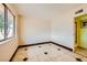 Neutral colored bedroom offers natural light from a window and tile floors at 4214 Bay Cir, Las Vegas, NV 89122