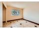 Well-lit bedroom with tile floors, closet, and a window with views of the outdoors at 4214 Bay Cir, Las Vegas, NV 89122