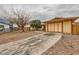 Single-story home with a gravel yard, mature trees, and a private driveway at 4214 Bay Cir, Las Vegas, NV 89122