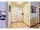 Clean hallway featuring ceramic tile flooring and multiple storage closets at 4214 Bay Cir, Las Vegas, NV 89122