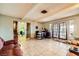 Large living room featuring tile flooring, neutral walls, and multiple seating areas at 4214 Bay Cir, Las Vegas, NV 89122