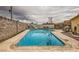 Large in-ground pool surrounded by concrete and rock landscaping at 4214 Bay Cir, Las Vegas, NV 89122