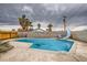 Outdoor pool with lounge chairs, slide, and mature palm trees at 4214 Bay Cir, Las Vegas, NV 89122