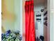 Shower area with striped tile, a red patterned curtain, and metal fixtures at 4214 Bay Cir, Las Vegas, NV 89122
