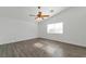 Bedroom features wood-look floors, ceiling fan, and a large window at 4929 Morning Falls Ave, Las Vegas, NV 89131