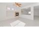 Bright, open-concept living space with recessed lighting, tile floors and fireplace at 4929 Morning Falls Ave, Las Vegas, NV 89131