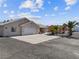 House exterior showcasing a two-car garage and desert landscaping at 521 Intrepid St, Pahrump, NV 89048