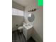 Clean bathroom featuring a white vanity, round mirror, and gray floor at 521 S Maryland Pkwy # A10, Las Vegas, NV 89101