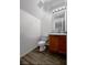 Small bathroom with wood cabinets, toilet and vinyl flooring at 5960 Palmilla St # 3, North Las Vegas, NV 89031