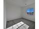 Bright bedroom with carpet flooring and large window at 5960 Palmilla St # 3, North Las Vegas, NV 89031