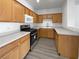 Modern kitchen with wood cabinets, stainless steel appliances, and light counters at 5960 Palmilla St # 3, North Las Vegas, NV 89031