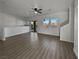 Open living room with hardwood floors and access to balcony at 5960 Palmilla St # 3, North Las Vegas, NV 89031