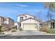 Two-story house with beige exterior, two-car garage, and landscaping at 6650 Apollos Gate Ct, Las Vegas, NV 89142