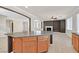 Large kitchen island with dark countertop and wooden cabinets at 6650 Apollos Gate Ct, Las Vegas, NV 89142