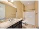 Clean bathroom with a bathtub, toilet and dark brown vanity at 7260 Fruitful Harvest Ave, Las Vegas, NV 89131