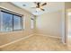 Spacious bedroom with large window, tile floors and ceiling fan at 7260 Fruitful Harvest Ave, Las Vegas, NV 89131