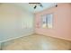 Charming bedroom with pink and grey walls, ceiling fan at 7260 Fruitful Harvest Ave, Las Vegas, NV 89131