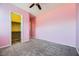 Spacious bedroom with pink walls, ceiling fan and a large closet at 7260 Fruitful Harvest Ave, Las Vegas, NV 89131